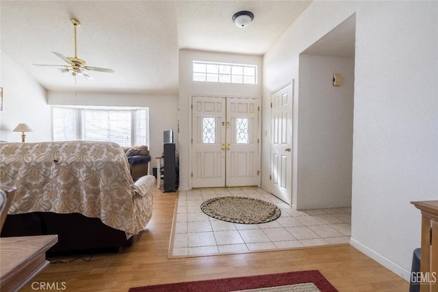 entryway with ceiling fan and light hardwood / wood-style flooring