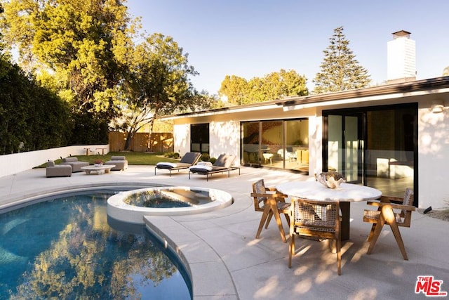 view of pool featuring an in ground hot tub and a patio