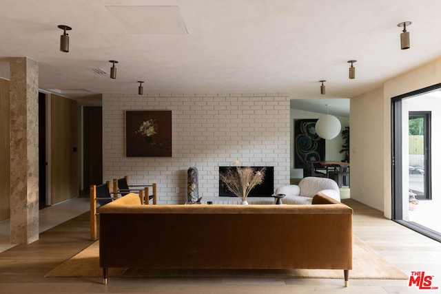 living room featuring a fireplace and light hardwood / wood-style floors