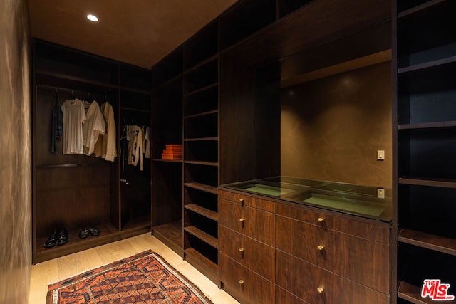 walk in closet featuring light hardwood / wood-style floors