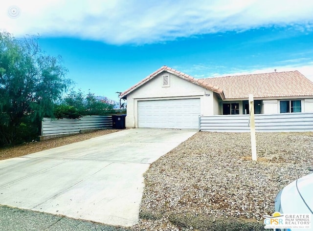 ranch-style home featuring a garage