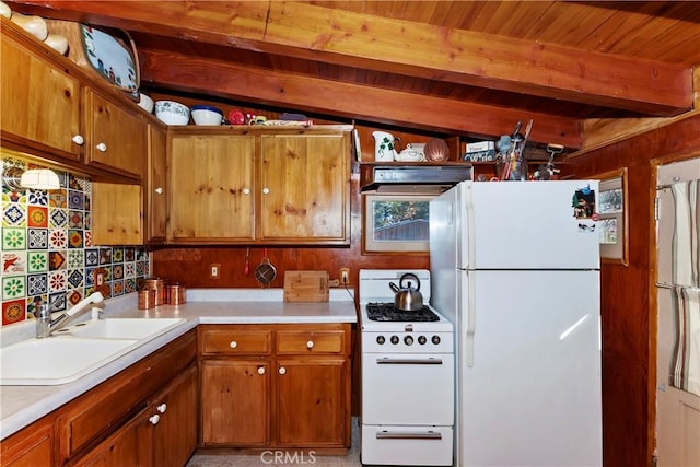 kitchen featuring vaulted ceiling with beams, white appliances, range hood, and sink