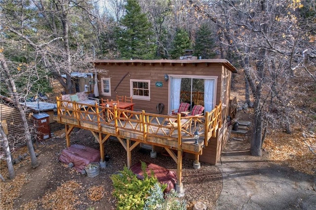 rear view of house featuring a wooden deck