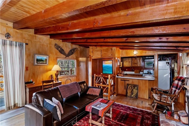 living room featuring vaulted ceiling with beams, wooden walls, light hardwood / wood-style flooring, and wood ceiling