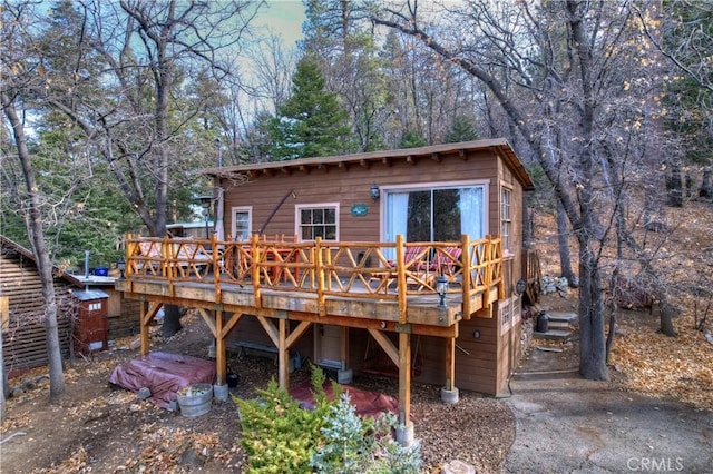 rear view of house with a wooden deck