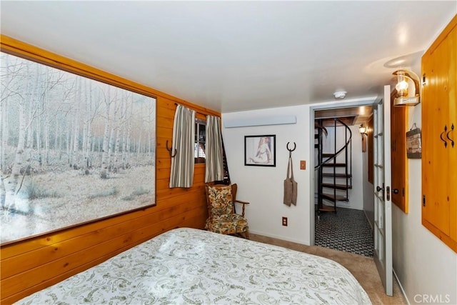 bedroom featuring wood walls, a closet, and carpet