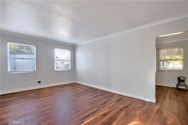 spare room with dark hardwood / wood-style flooring and ornamental molding