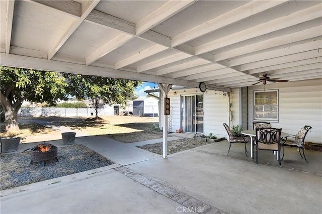 view of patio featuring ceiling fan and an outdoor fire pit