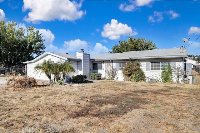 single story home with central air condition unit and a front lawn