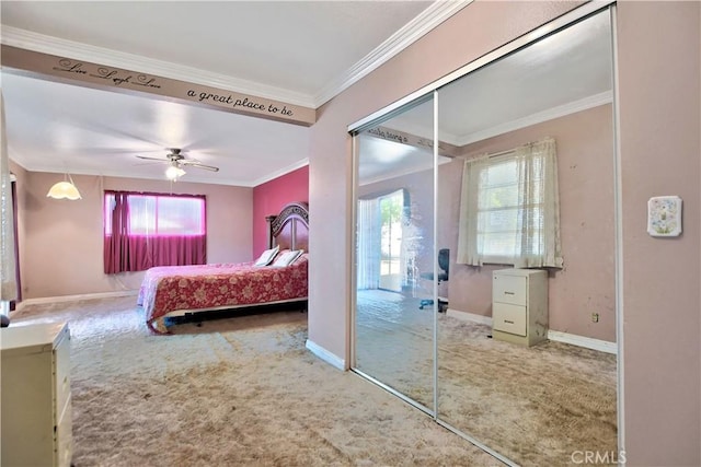 carpeted bedroom featuring multiple windows, ceiling fan, a closet, and ornamental molding