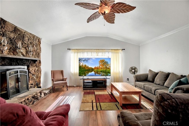 living room with a fireplace, ornamental molding, lofted ceiling, and hardwood / wood-style flooring