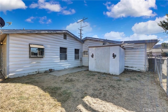 rear view of property with a lawn