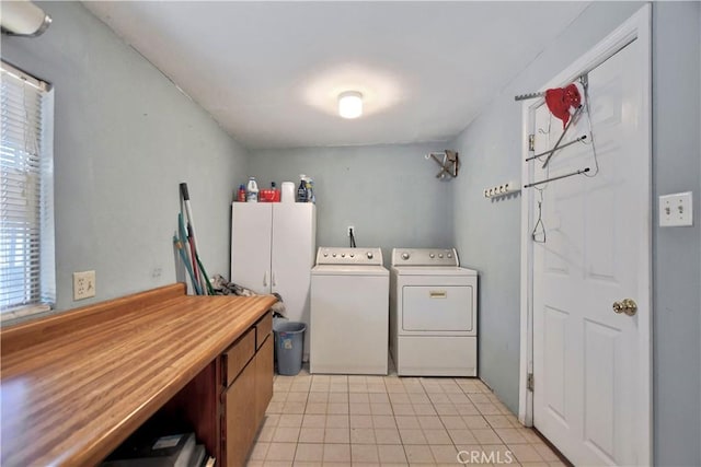 clothes washing area featuring cabinets and washing machine and dryer