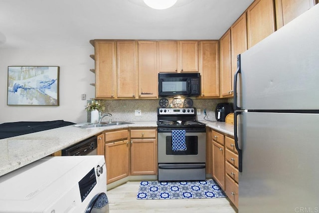 kitchen featuring light stone countertops, stainless steel appliances, tasteful backsplash, sink, and kitchen peninsula