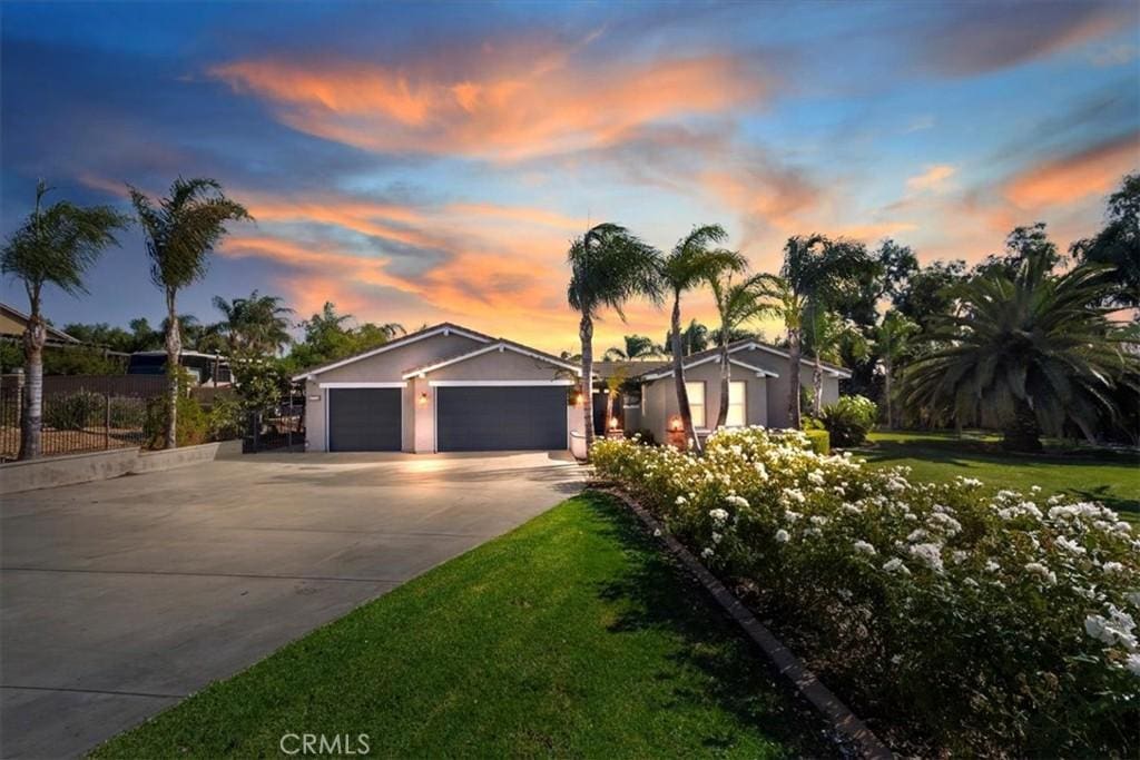 ranch-style home with a yard and a garage