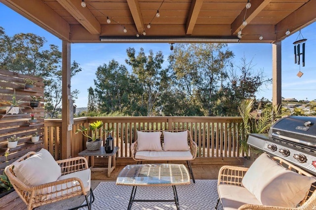 wooden terrace featuring an outdoor living space and a grill