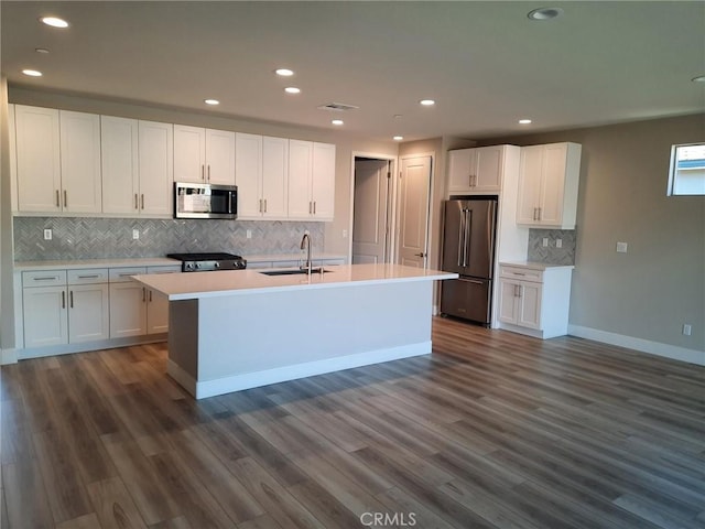 kitchen featuring dark wood-type flooring, white cabinetry, and appliances with stainless steel finishes