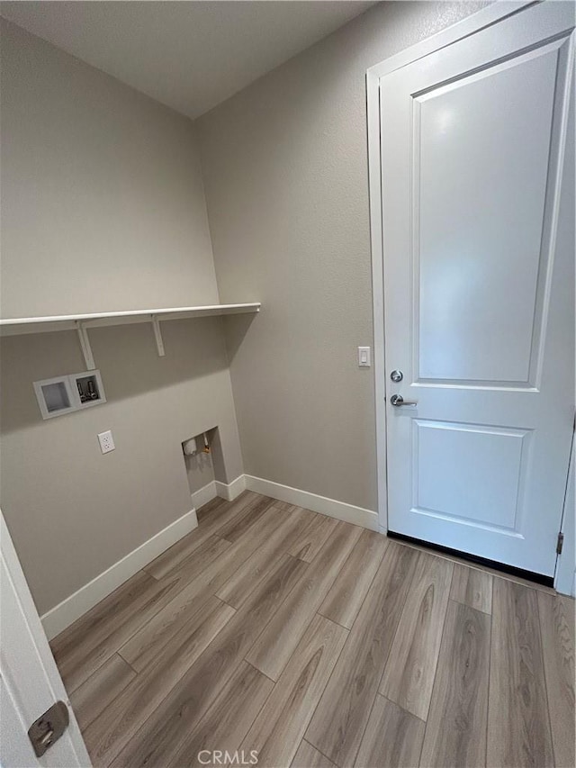 clothes washing area with washer hookup and light wood-type flooring