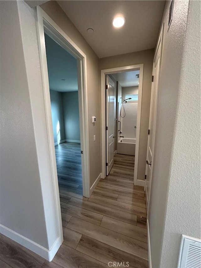 corridor featuring light hardwood / wood-style flooring