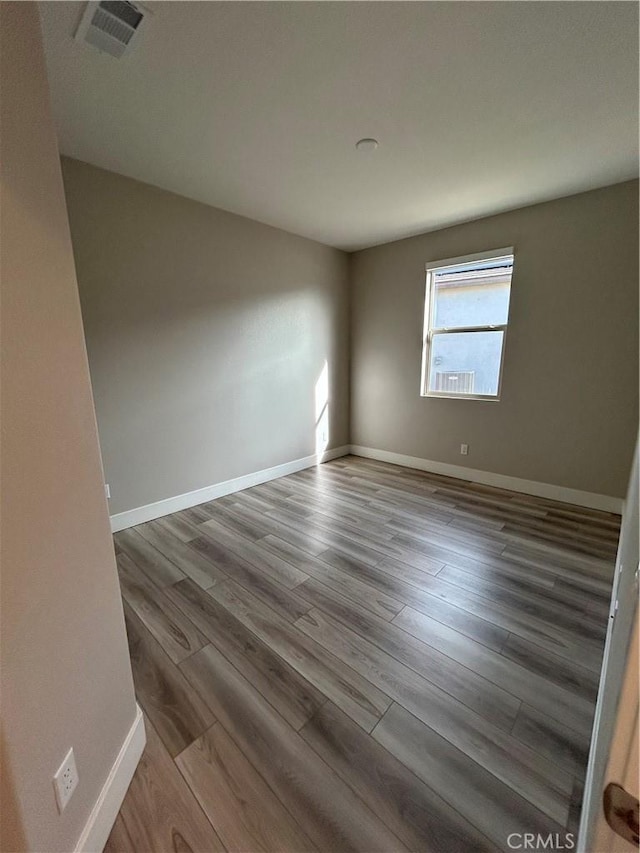 empty room with hardwood / wood-style floors