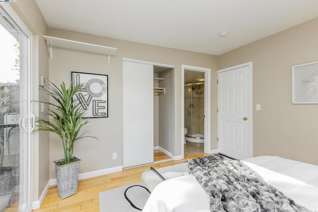 bedroom featuring wood-type flooring and connected bathroom