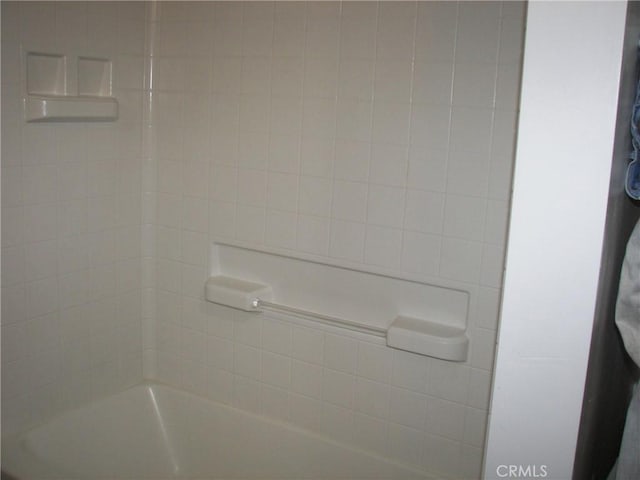 interior details with tiled shower / bath combo