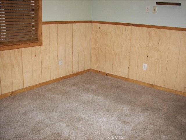 carpeted empty room with wooden walls