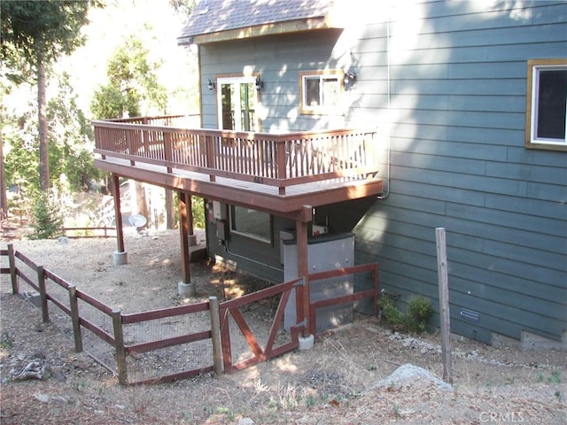 back of property featuring a wooden deck