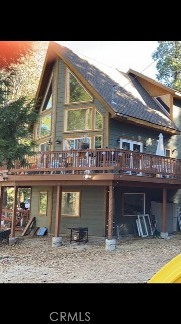 back of property with a wooden deck