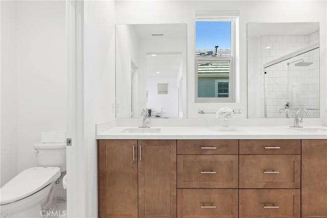 bathroom with walk in shower, vanity, and toilet