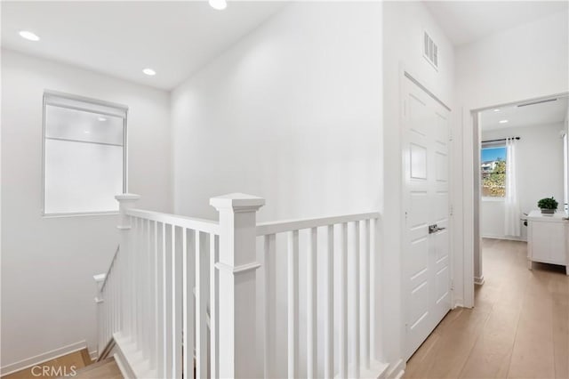 hallway with light hardwood / wood-style flooring