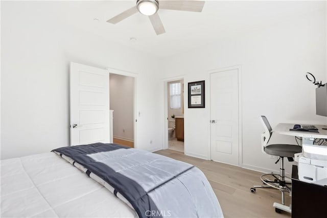 bedroom with ensuite bath, light hardwood / wood-style flooring, and ceiling fan