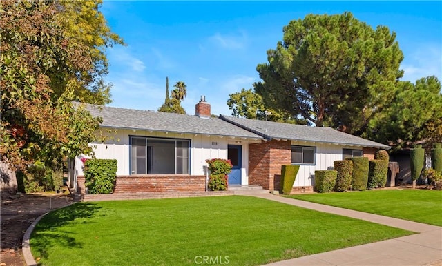 ranch-style home with a front lawn