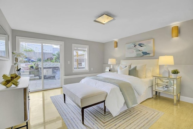 bedroom with light wood-type flooring and access to exterior