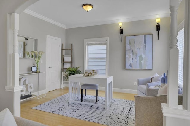 office space with light wood-type flooring and crown molding