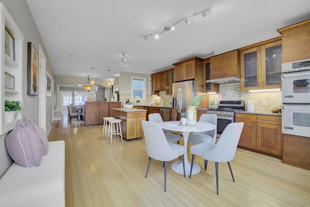 dining space with light wood-type flooring