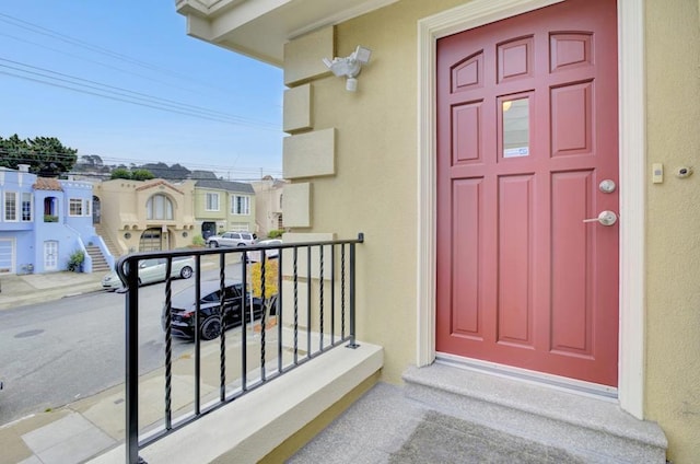 view of exterior entry featuring a balcony