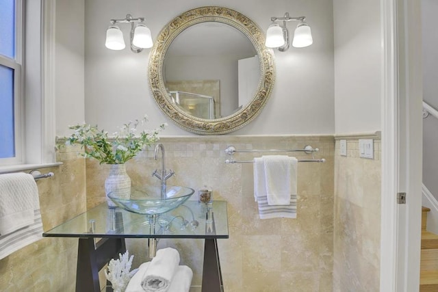 bathroom featuring an enclosed shower and sink