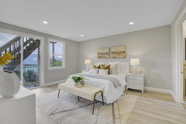 bedroom with light hardwood / wood-style floors and access to outside