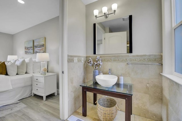 bathroom featuring vanity, tile walls, and hardwood / wood-style flooring