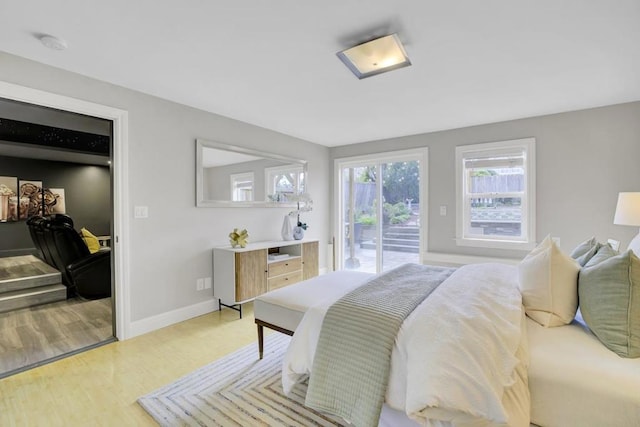 bedroom featuring access to exterior and light hardwood / wood-style flooring