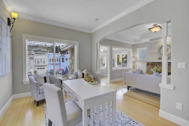 dining area featuring crown molding and light hardwood / wood-style floors