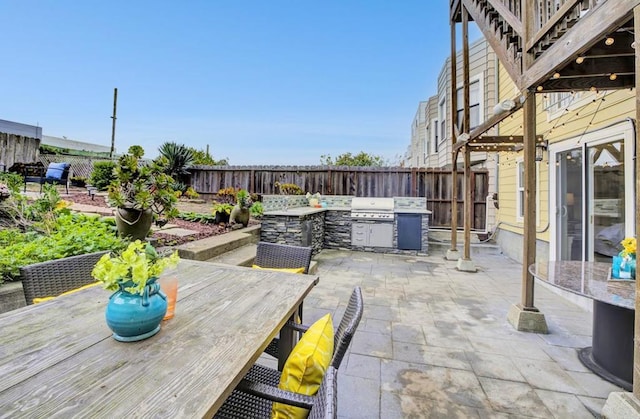 view of patio featuring exterior kitchen and grilling area