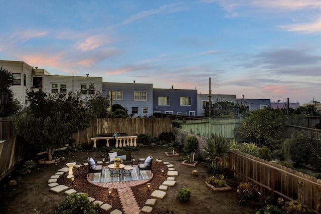 yard at dusk featuring a patio