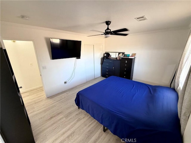 bedroom with ceiling fan, wood-type flooring, and crown molding