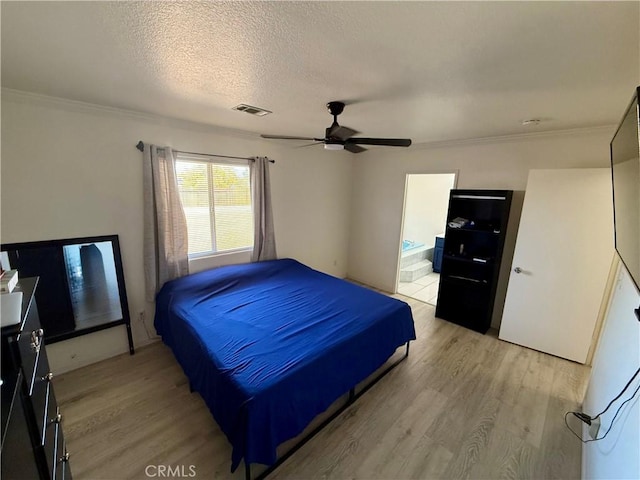bedroom with connected bathroom, ceiling fan, crown molding, a textured ceiling, and light wood-type flooring