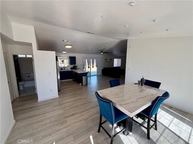 dining space with hardwood / wood-style flooring and ceiling fan