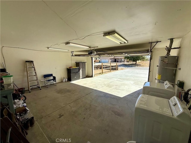 garage featuring strapped water heater, separate washer and dryer, and a garage door opener