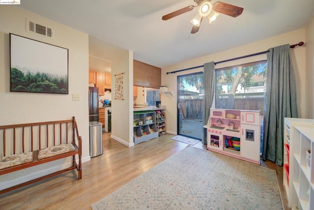 playroom featuring ceiling fan and light hardwood / wood-style flooring