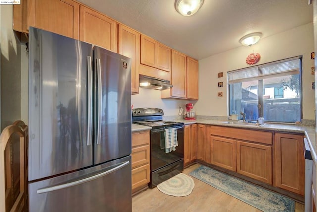 kitchen with ventilation hood, sink, light wood-type flooring, black range with electric cooktop, and stainless steel refrigerator